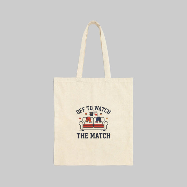 Beige tote bag with 'Off to Watch the Match' text and graphic on a white background
