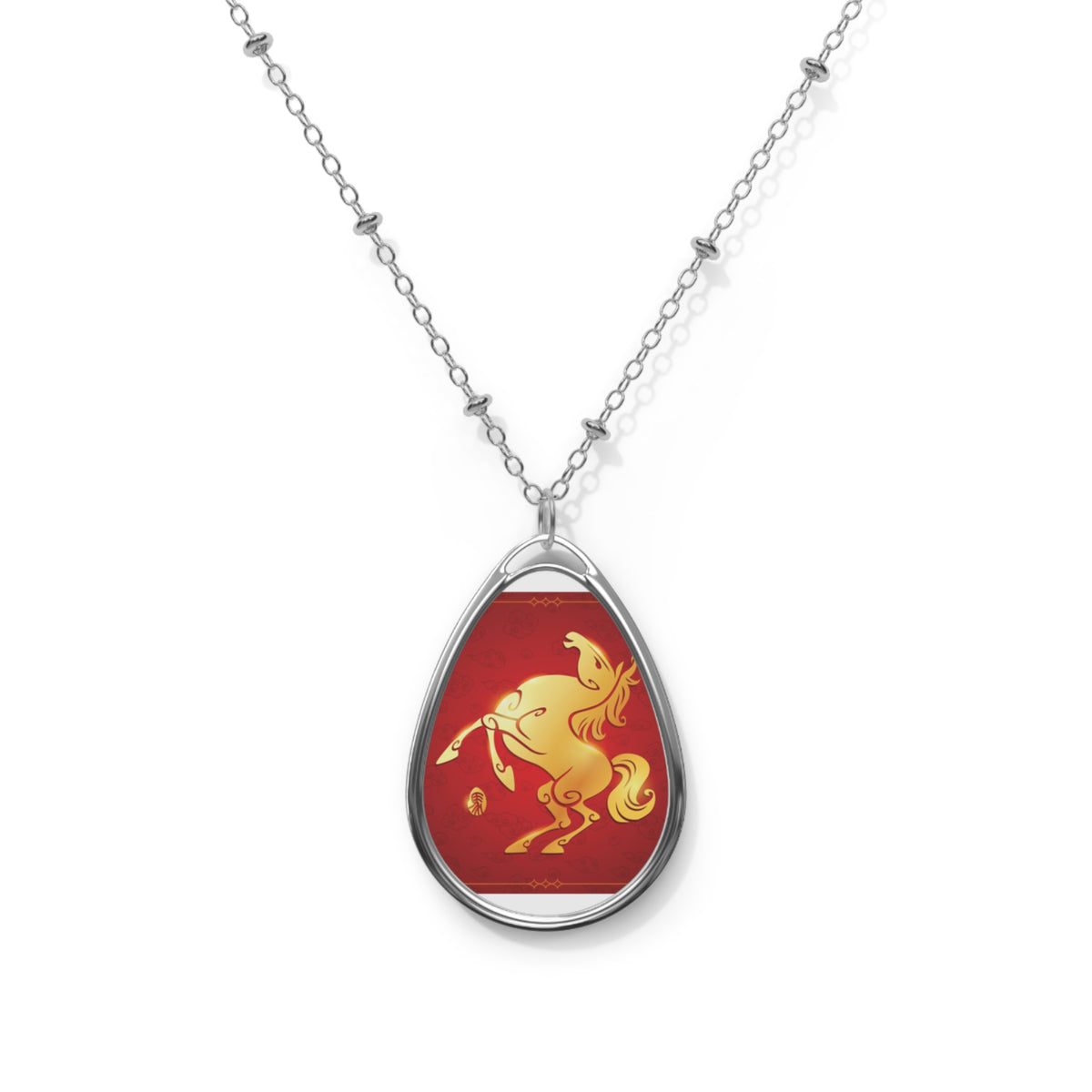 Teardrop-shaped pendant with a red background and gold horse design on a white chain.