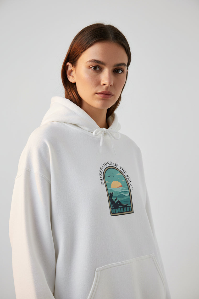White hoodie with a graphic design on the chest against a white background