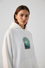 White hoodie with a graphic design on the chest against a white background