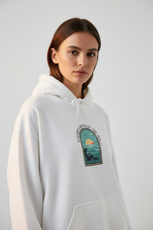 White hoodie with a graphic design on the chest against a white background