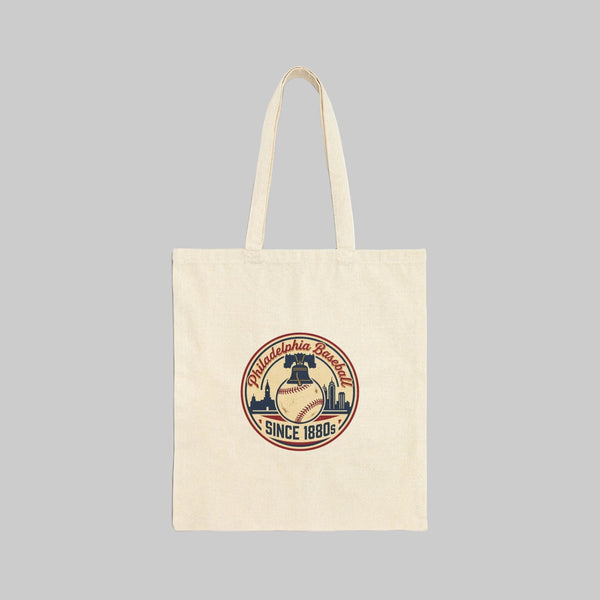 Beige tote bag with a decorative emblem on a white background