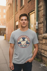 Gray t-shirt with a baseball-themed graphic and text on a white background