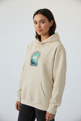 Beige hoodie with a circular logo featuring a paw print and text on a white background