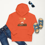 Orange hoodie with graphic design on a white background, surrounded by jeans, sandals, and sunglasses.